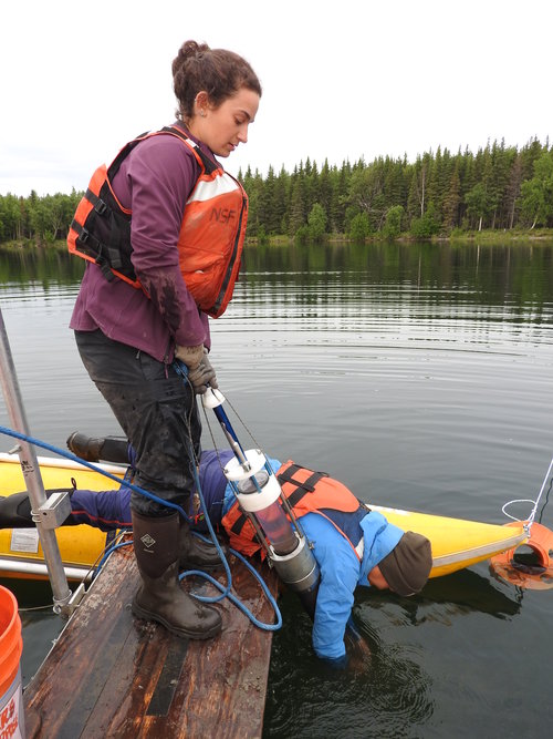 Ellie Broadman and Annie Wong retrieving surface sediments with a Uwitec percussion corer at Kelly Lake