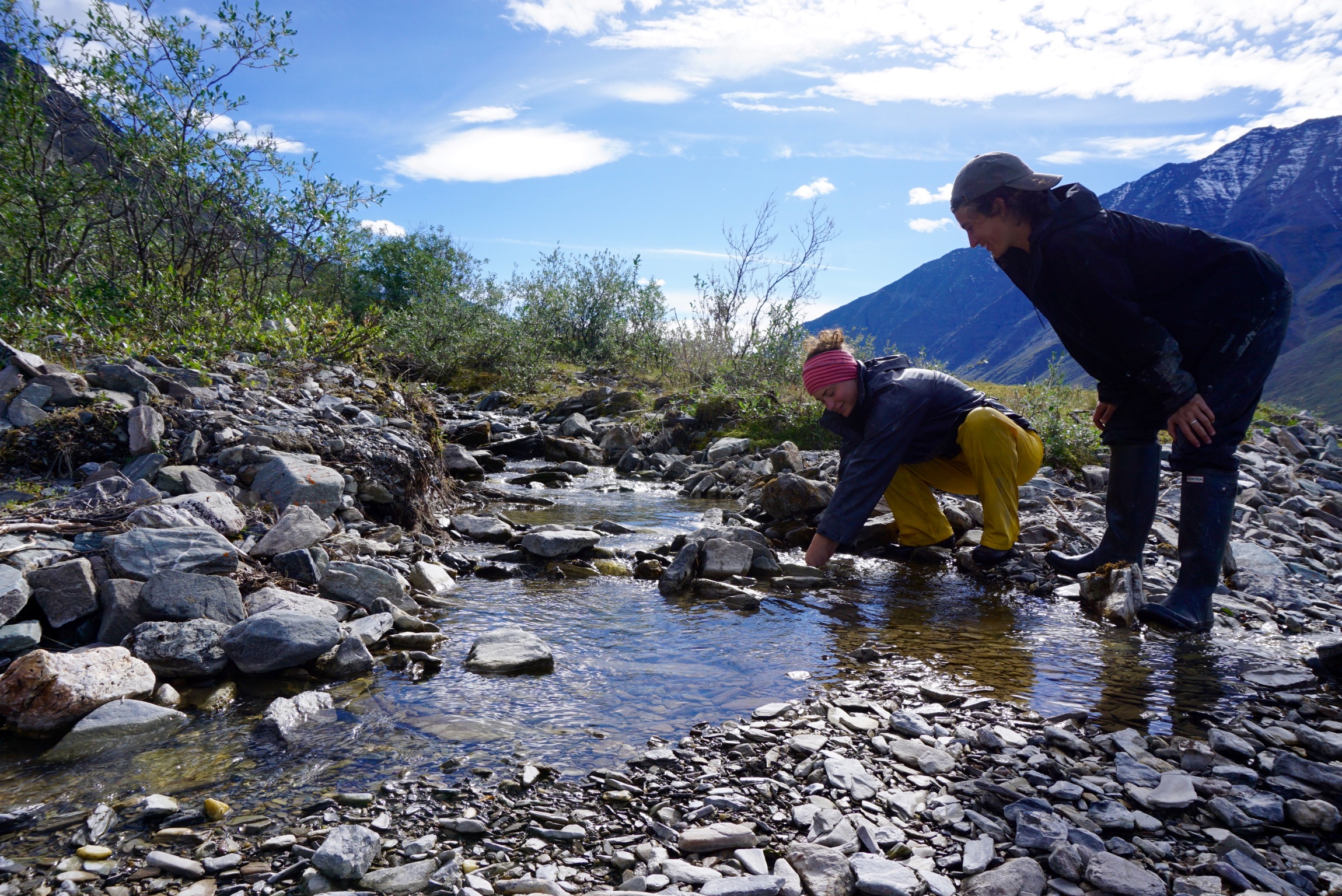 Stephanie Arcusa and Ellie Broadman sample water feeding into Lake Peters