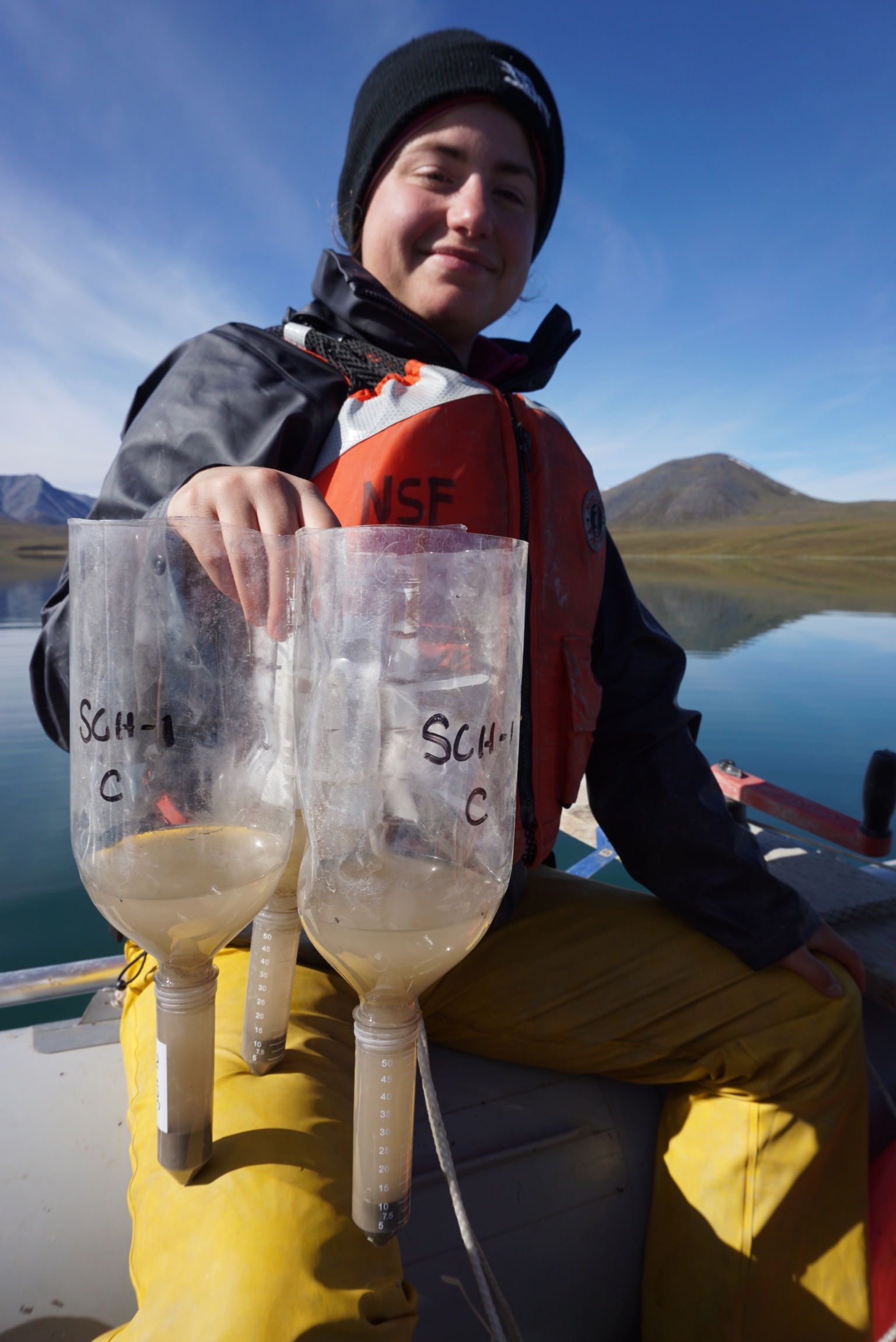 Stephanie Arcusa collects sediment traps from Lake Peters